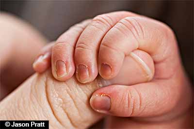 Newborn hand with folds